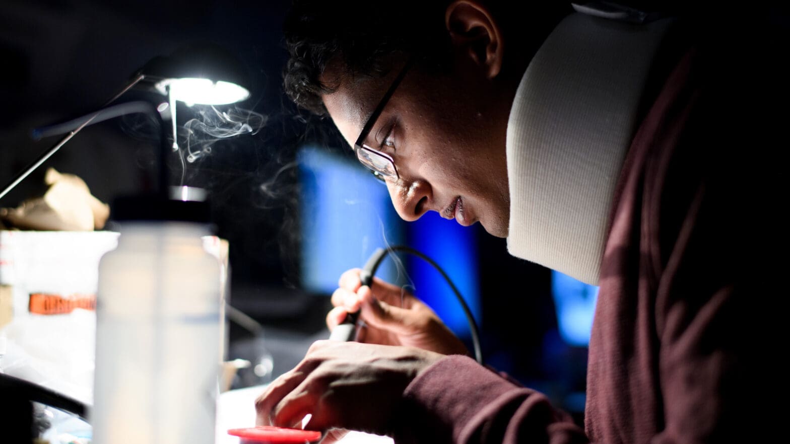 Researcher solders in lab.