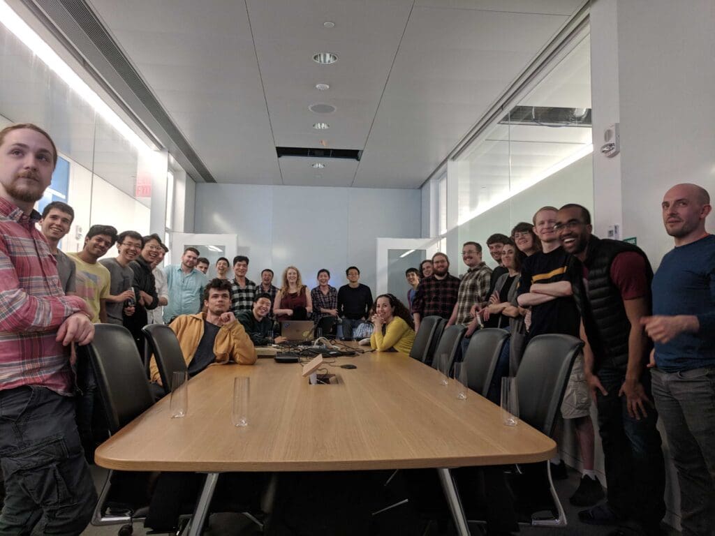 Large group of researchers in a conference room.